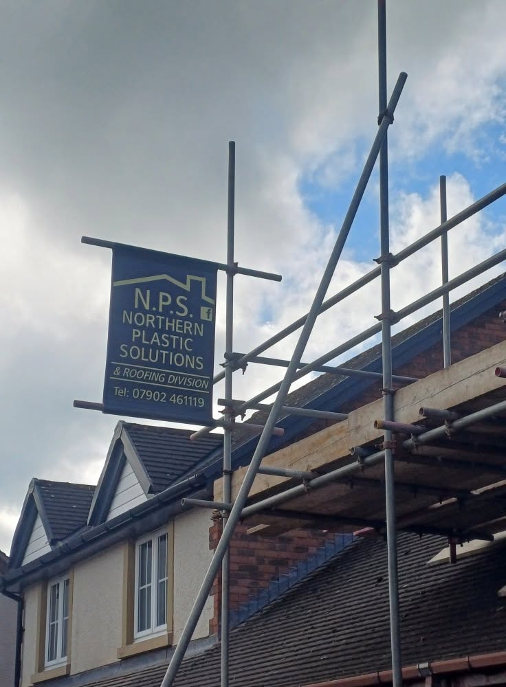 NPS site signage on a scaffolded roofing project by Northern Plastic Solutions